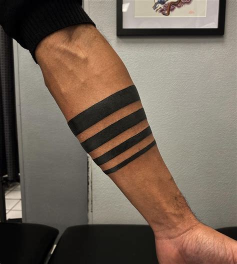 arm band tattoo meaning|solid black arm tattoo meanings.